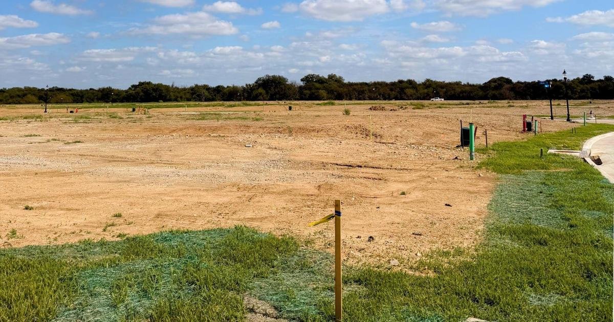 Graded dirt and a survey stake on the Bryson Ranch development site in Pilot Point TX