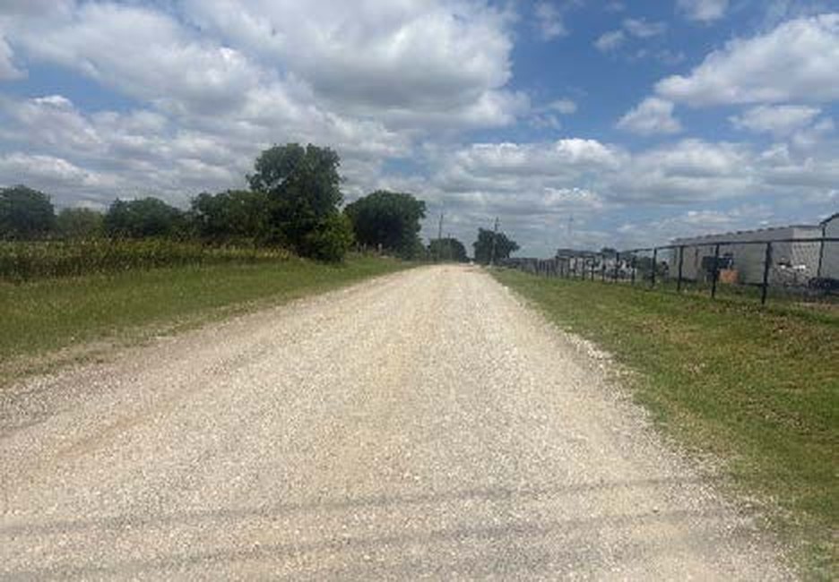 Gravel Little Elm Creek Road facing east along the north edge of the Taylor Ranch site in Gunter TX