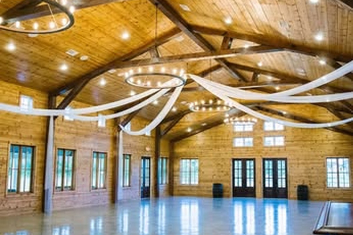 Interior event hall at Bella Terra Venue Gunter Texas with wood beams and chandeliers