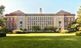 Brick and stone school campus exterior under a clear North Texas morning sky, manicured lawn and trees—welcoming editorial photo for Grayson County school districts parent guide