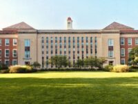 Brick and stone school campus exterior under a clear North Texas morning sky, manicured lawn and trees—welcoming editorial photo for Grayson County school districts parent guide