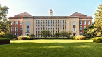 Brick and stone school campus exterior under a clear North Texas morning sky, manicured lawn and trees—welcoming editorial photo for Grayson County school districts parent guide