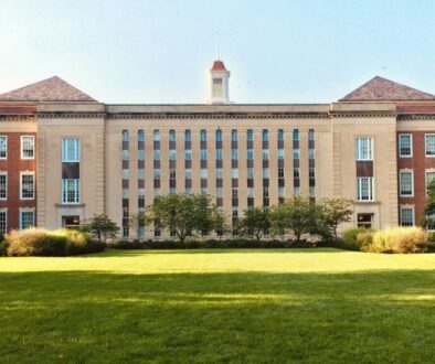 Brick and stone school campus exterior under a clear North Texas morning sky, manicured lawn and trees—welcoming editorial photo for Grayson County school districts parent guide