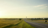 Quiet North Texas small-city scene near Denison—historic downtown and lake-adjacent prairie light, no people or text—editorial header for a moving guide.