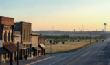 Scenic North Texas small-town lakeside corridor near Lake Texoma at soft morning light, rolling shoreline and open sky—no people, no seals, no text