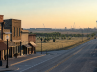 Gunter, Texas main street and highway corridor at sunrise, with distant construction on the horizon
