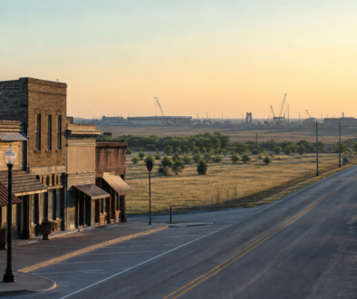 Gunter, Texas main street and highway corridor at sunrise, with distant construction on the horizon