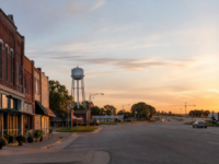 Van Alstyne, Texas main street and highway corridor at sunrise, with distant growth on the horizon