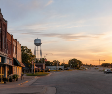 Van Alstyne, Texas main street and highway corridor at sunrise, with distant growth on the horizon