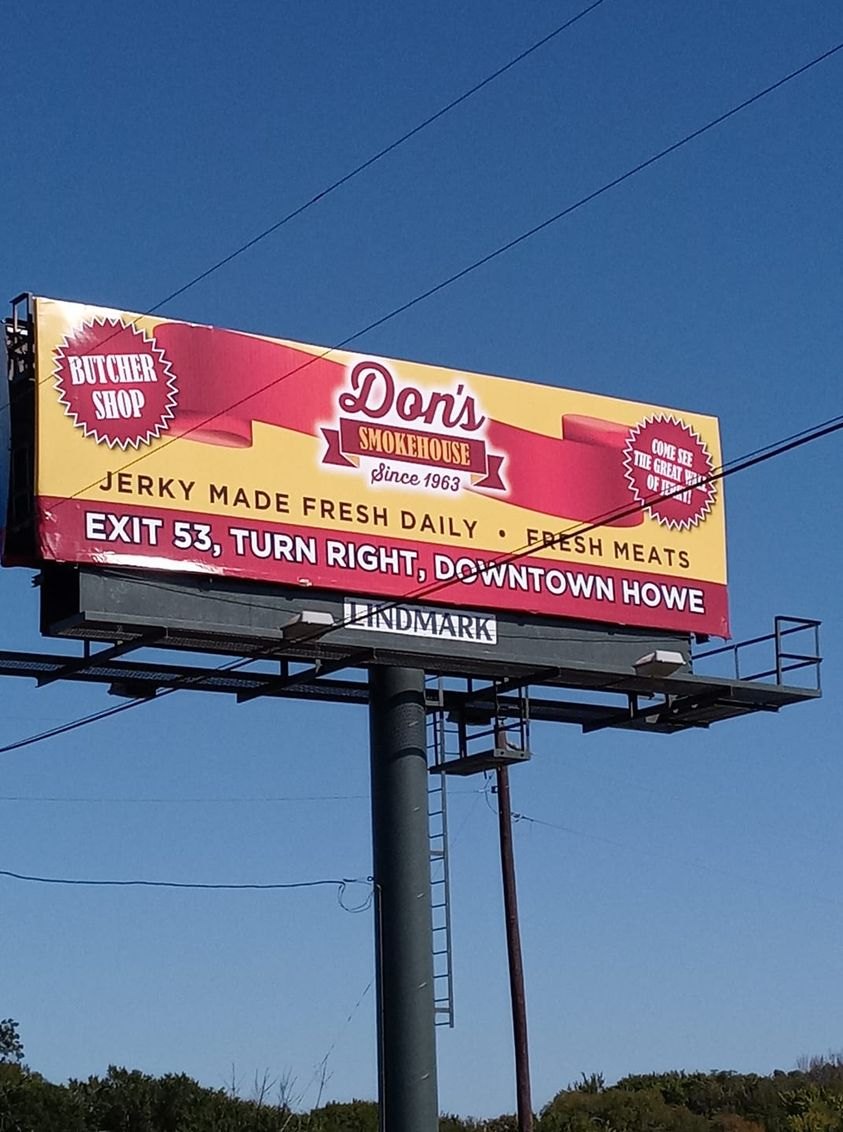 Don's Smokehouse billboard reading Jerky made fresh daily and Exit 53, turn right, downtown Howe