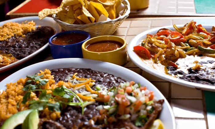 Plates of fajitas, rice, black beans, and pico de gallo with chips and salsa at Gabriela's Mexican Cocina in Howe