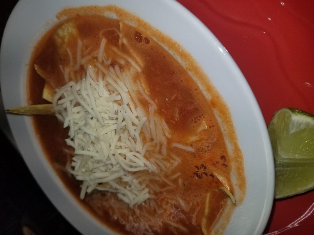 Bowl of soup topped with shredded cheese and a lime wedge at Gabriela's Mexican Cocina in Howe