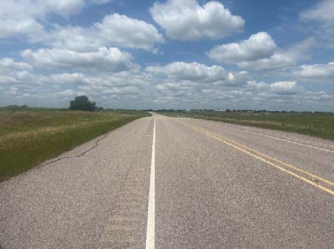 Two-lane Grayson Parkway facing north past open farmland at the Platinum Ranch site in Gunter TX