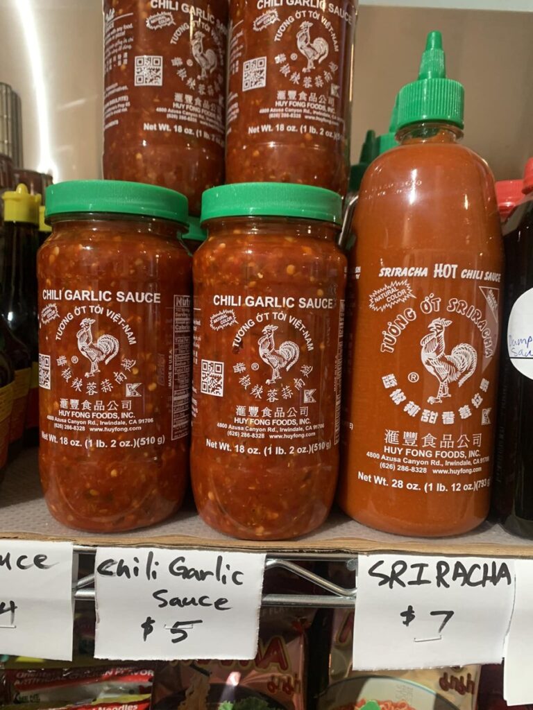 Bottled chili garlic and sriracha sauces for sale at Hana's Cafe and Market Howe