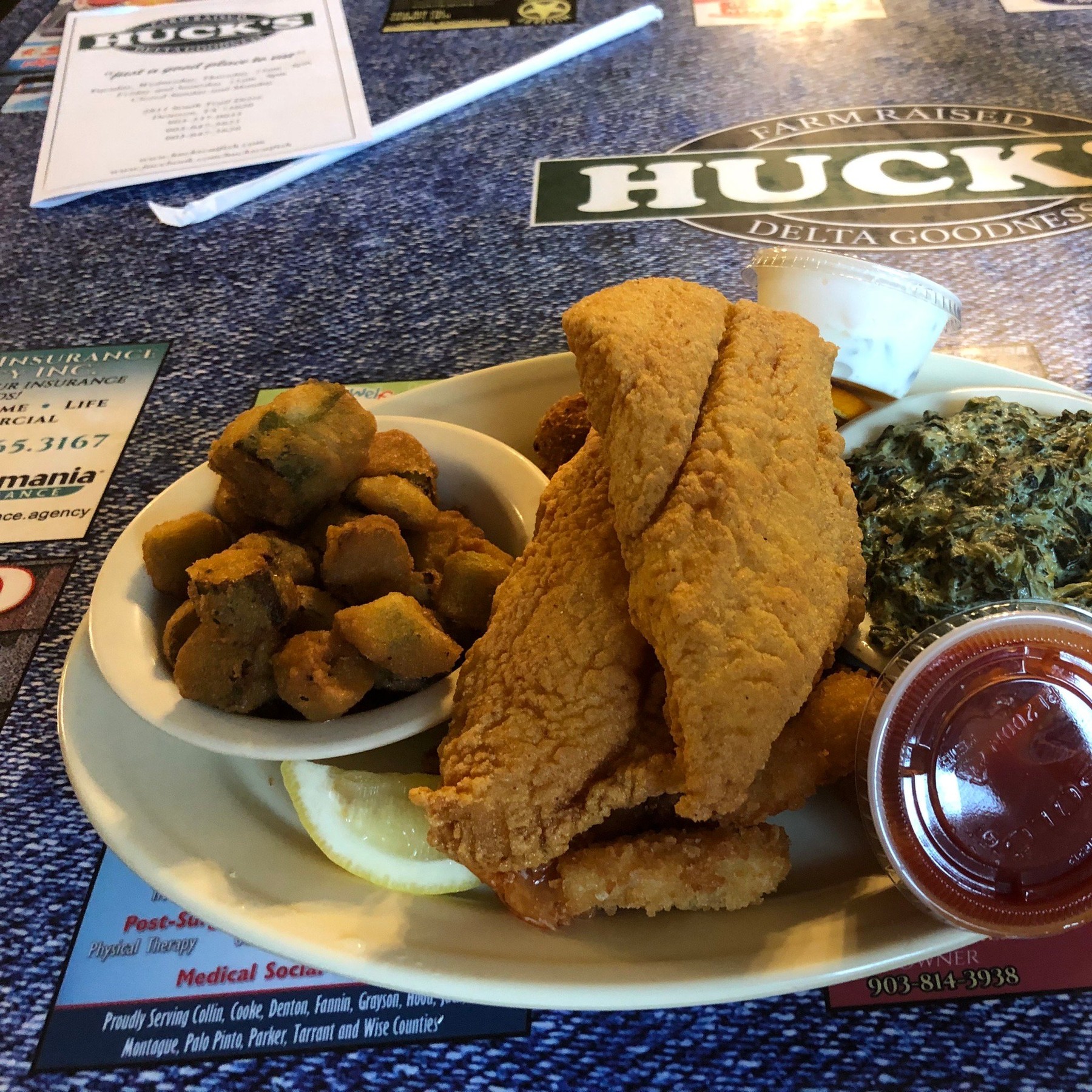 Cornmeal-battered fried catfish with okra, greens, and hush puppy at Huck's Catfish Denison