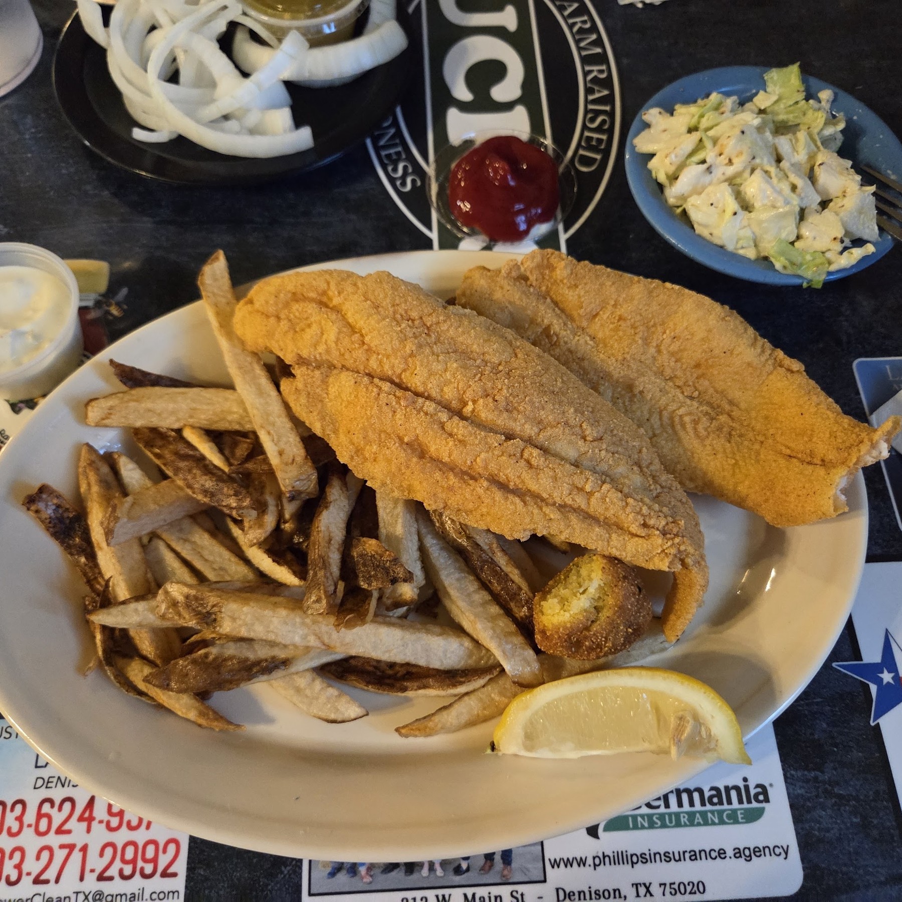 Fried catfish dinner with fries, hush puppy, and coleslaw at Huck's Catfish Denison