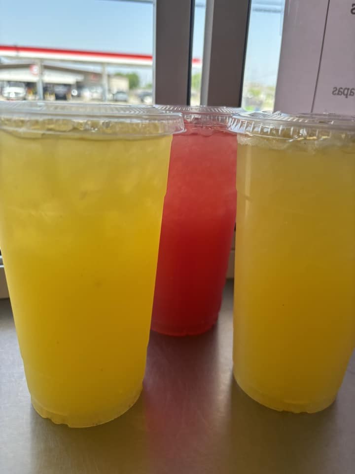 Cups of yellow and red cold fruit drinks at the Marilina's Kitchen food truck in Gunter
