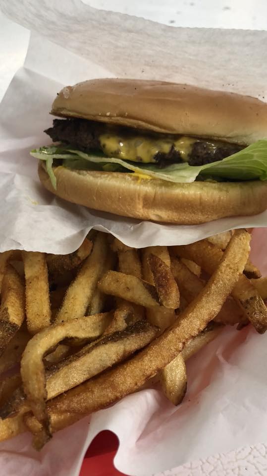 Cheeseburger with lettuce and a pile of fries at Watson's Drive In Denison